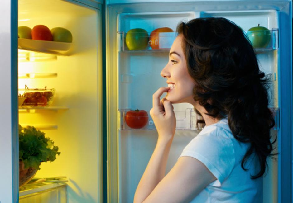 Žena proučava hranu u hladnjaku | Author: Thinkstock